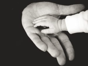 dad baby hands bw