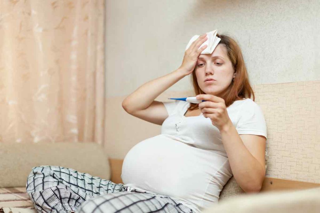 pregnant woman with thermometer